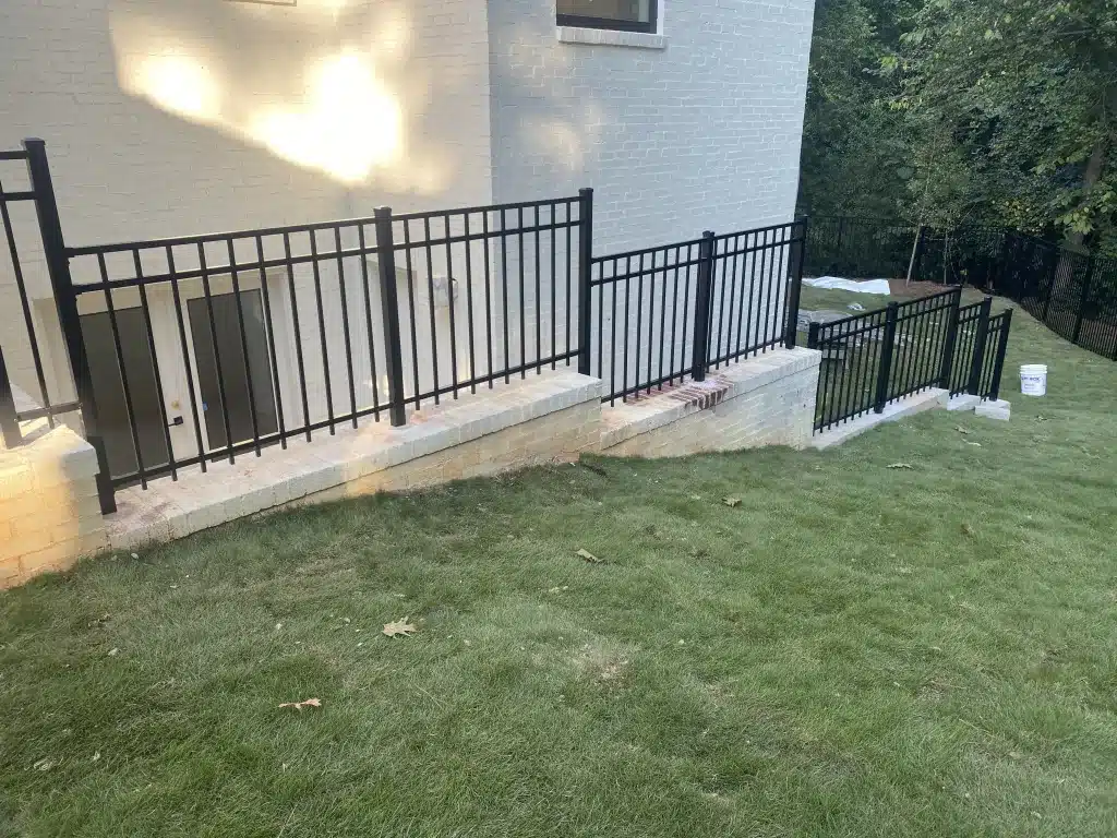 Modern aluminum railing system mounted on a retaining wall at a private residence