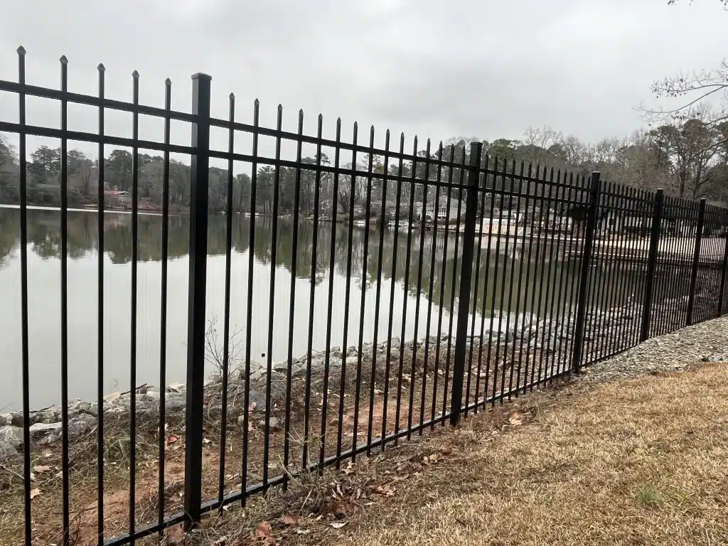 Decorative black steel fence installed beside lakefront yard in Roswell GA