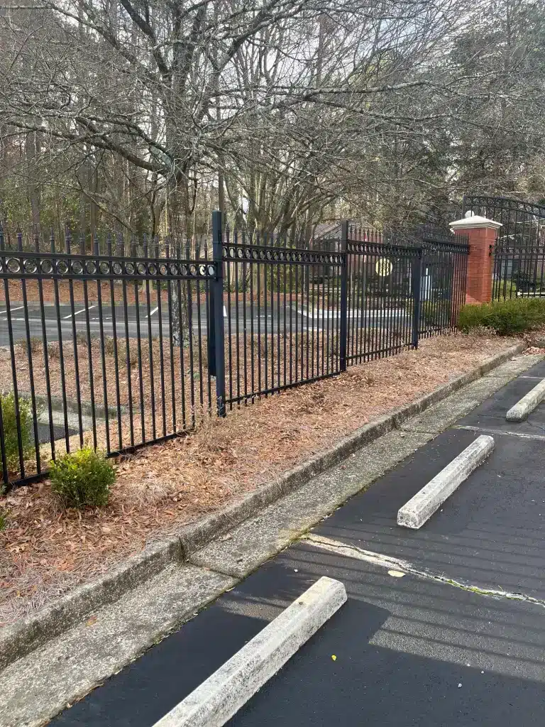 Decorative fencing around a commercial parking lot in Dunwoody, GA, installed by Chamblee Fence for added security and style.