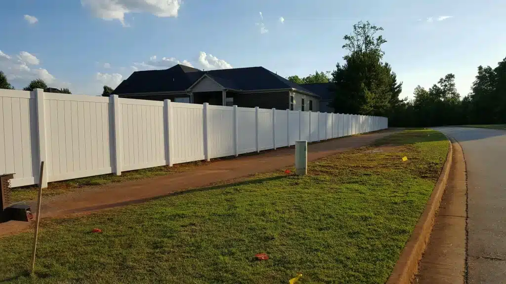Durable fencing installed along a residential property line in Dunwoody, GA by Chamblee Fence, offering low-maintenance boundary solutions.