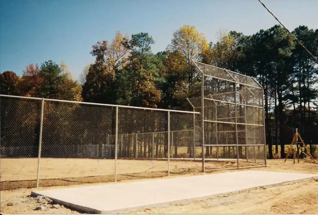 Perimeter fencing enclosing a sports facility in Lawrenceville, GA, installed by Chamblee Fence for safety and functionality.