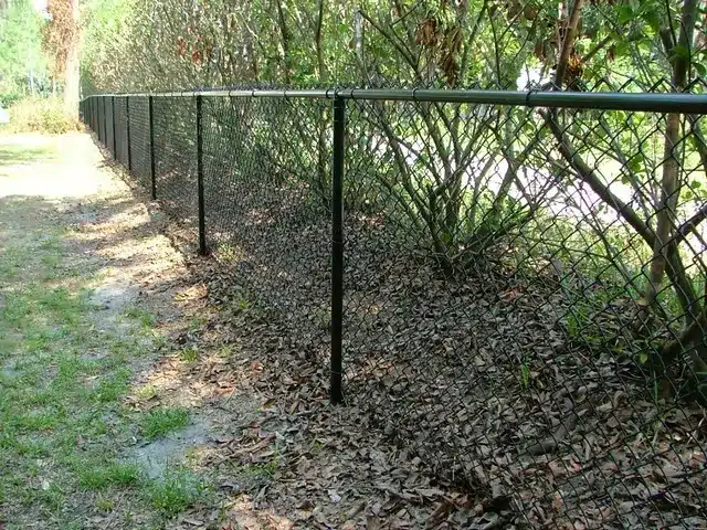 Chain-link vs vinyl fence side-by-side in Lawrenceville yard, comparing cost, durability, and style for local homeowners and businesses.