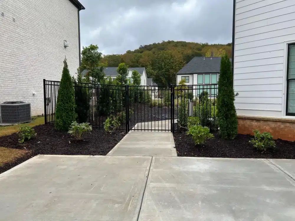 Black aluminum gate and fence installed along a residential walkway in Marietta, GA