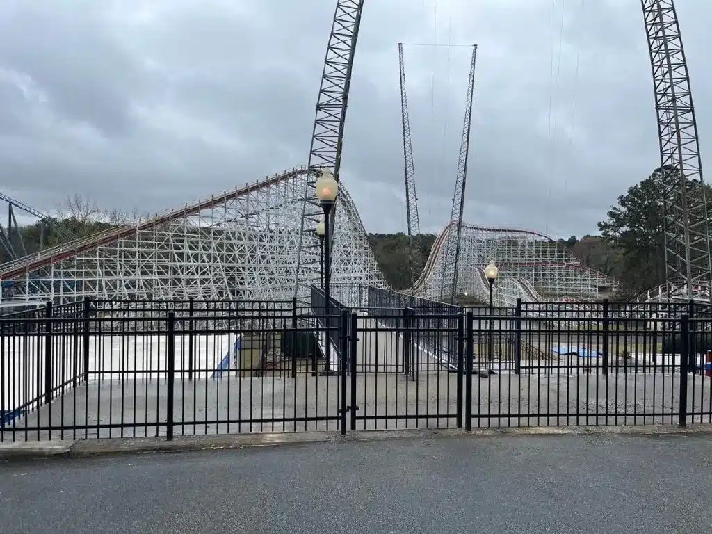 Black commercial aluminum fence & gate installed around an amusement park attraction in Marietta, GA