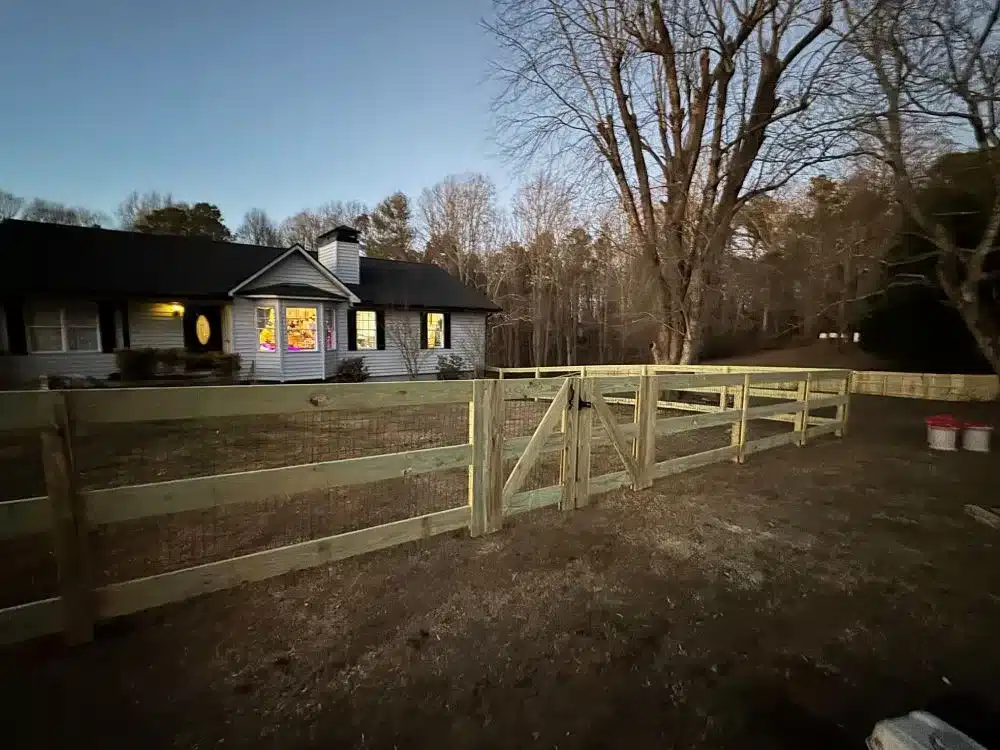 Split rail fence with wire mesh and gate installed on a residential property in Marietta, GA