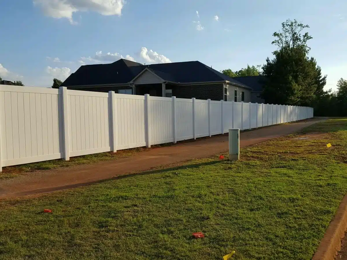 White vinyl privacy fence installed along a residential property line in Marietta, GA